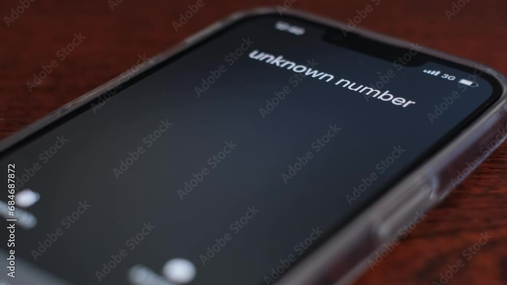 The cell phone on the table is ringing, the payer or bank teller. Unknown call