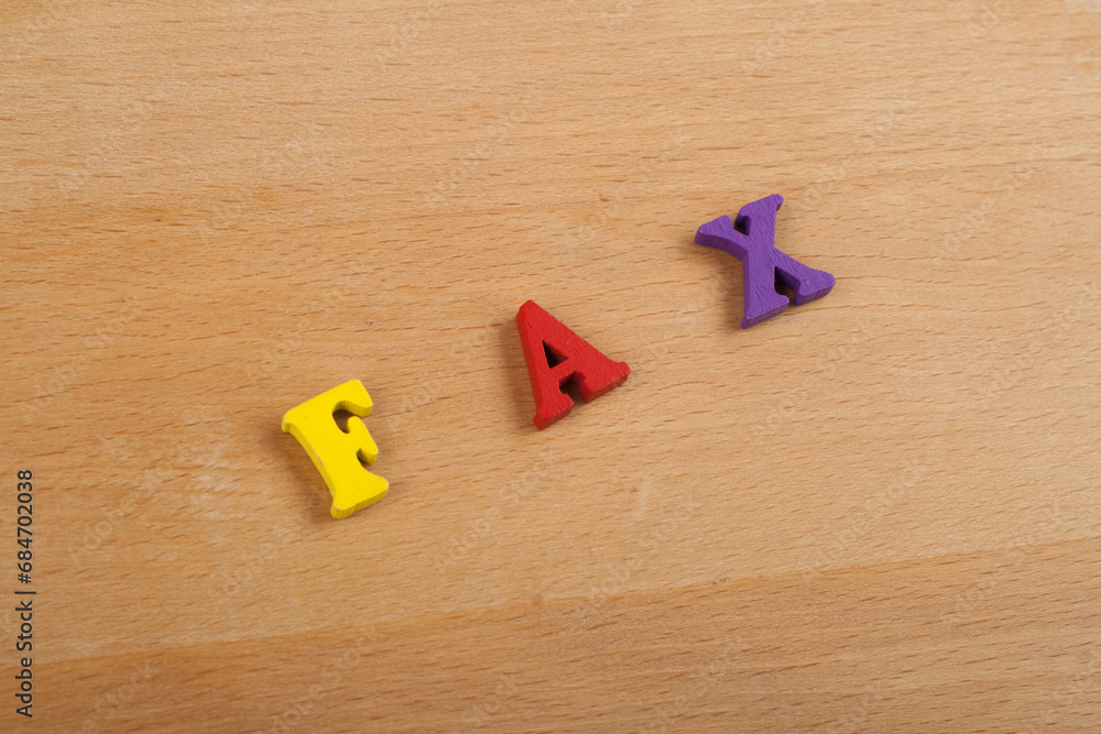 Obraz premium FAX word on wooden background composed from colorful abc alphabet block wooden letters, copy space for ad text. Learning english concept.