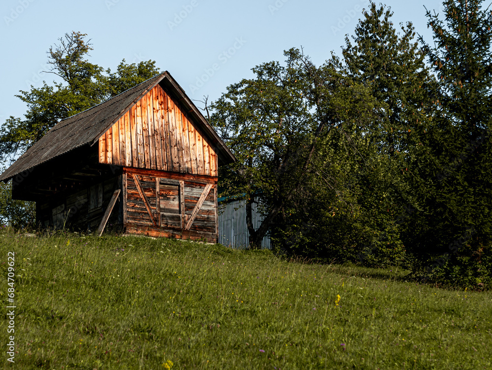 Old authentic wooden house with hayloft in scenic Carpathian mountains Ukraine, Europe, Transcarpathia region. Local countryside travel forest hiking trails. Cottagecore style vacation. Eco tourism. Old authentic wooden house with hayloft in scenic Carpathian mountains Ukraine, Europe, Transcarpathia region. Local countryside travel forest hiking trails. Cottagecore style vacation. Eco tourism.