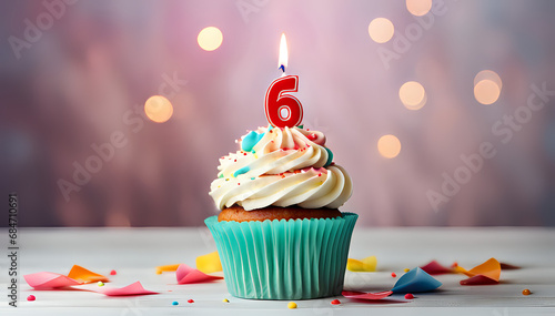 Birthday cupcake with lit birthday candle Number six for six years or sixth anniversary photo