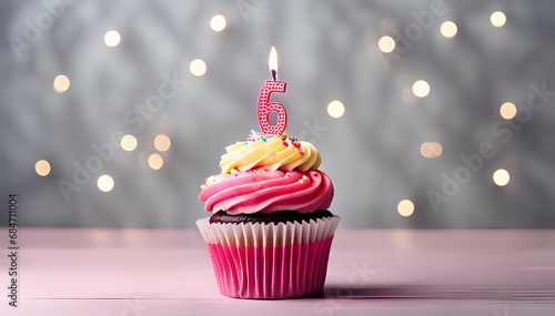 Birthday cupcake with lit birthday candle Number six for six years or sixth anniversary