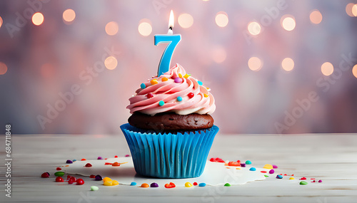Birthday cupcake with lit birthday candle Number seven for seven years or seventh anniversary photo