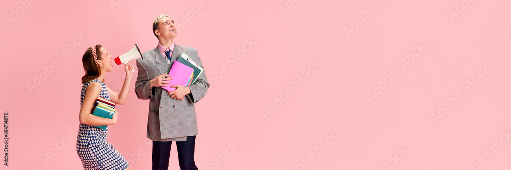 Young woman shouting in megaphone at young guy, employee standing with dreamy face against pink studio background. Concept of emotions, business, profession and occupation, lifestyle Young woman shouting in megaphone at young guy, employee standing with dreamy face against pink studio background. Concept of emotions, business, profession and occupation, lifestyle