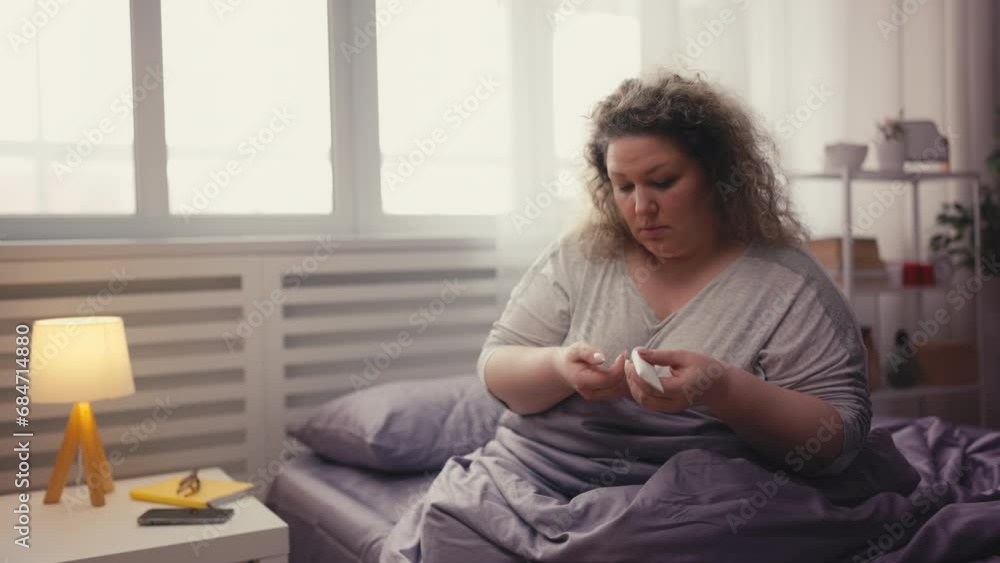 Overweight woman applying hand cream to dry elbow skin, taking care of body Overweight woman applying hand cream to dry elbow skin, taking care of body