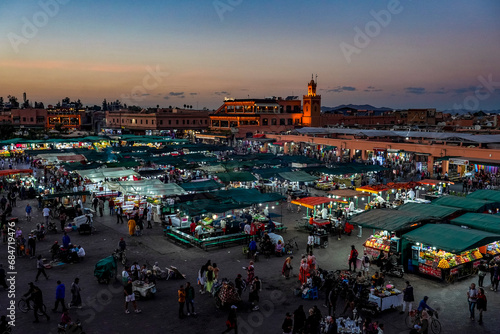 Morocco. Marrakesh. Night activity on Jemaa el Fna Square at sunset photo