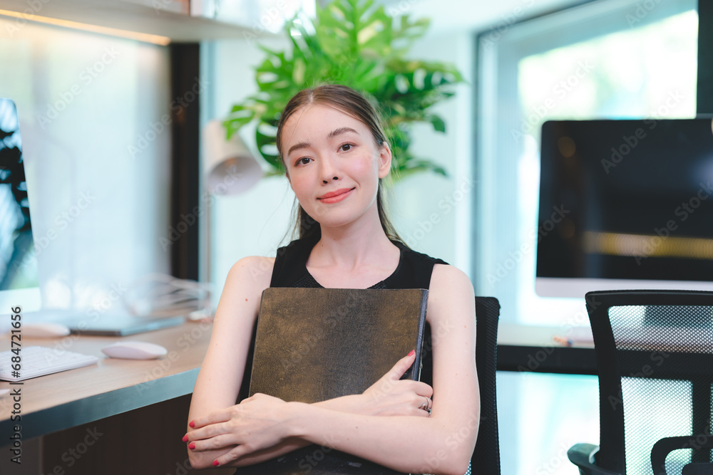 Portrait of smart young beautiful Asian business woman, successful female employee smiling with happy job, financial woman satisfied with the results of her work achievement in modern office Portrait of smart young beautiful Asian business woman, successful female employee smiling with happy job, financial woman satisfied with the results of her work achievement in modern office