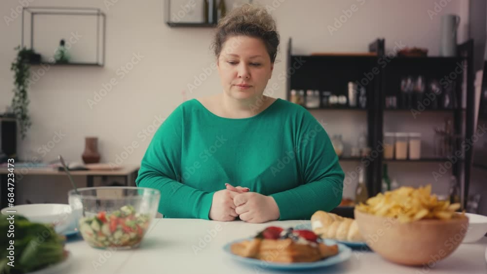 Overweight woman choosing between healthy food and unhealthy snacks, dieting Overweight woman choosing between healthy food and unhealthy snacks, dieting