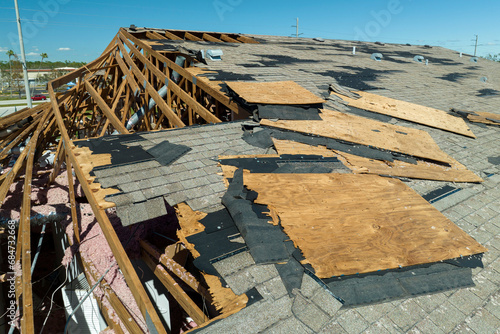Hurricane Ian destroyed house roof in Florida residential area. Natural disaster and its consequences