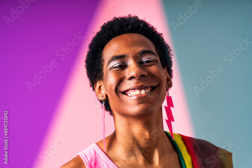 Fashionable homosexual man posing in studio - Fluid gender non binary hispanic  man posing in studio with fashionable clothing - concepts about LGBTQ, genderless and diversity photo