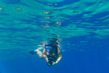 Young woman snorkeling in Red sea with the camera