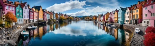 Large panoramic image of a colorful place with buildings, river and reflection in the water.