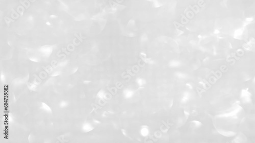 White background with bokeh and glitter.