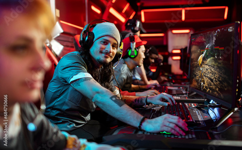 Portrait of a pro gamer in neon lit arena playing in tournament photo