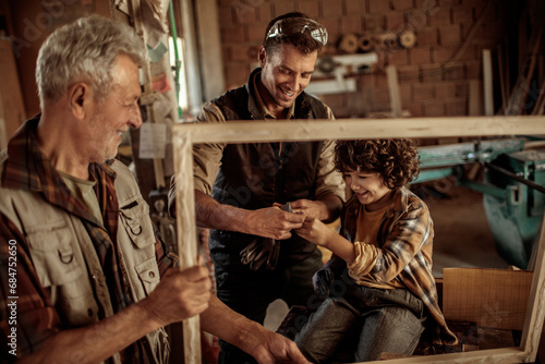 Multi generational family in the woodworking workshop