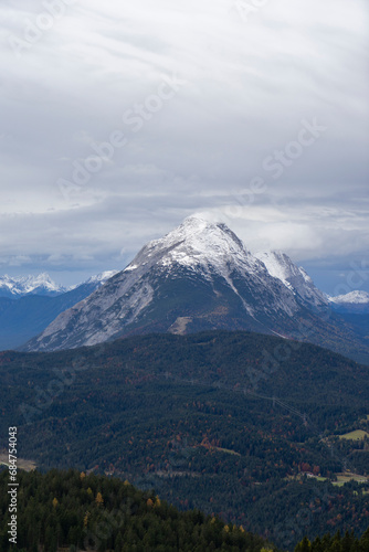 Hohe Munde, snowcovered summit of a standalone mountain in cloudy weather