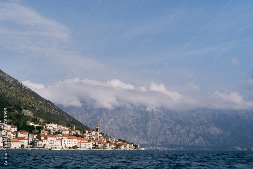 Coast of Perast with old stone houses at the foot of the mountains. Montenegro