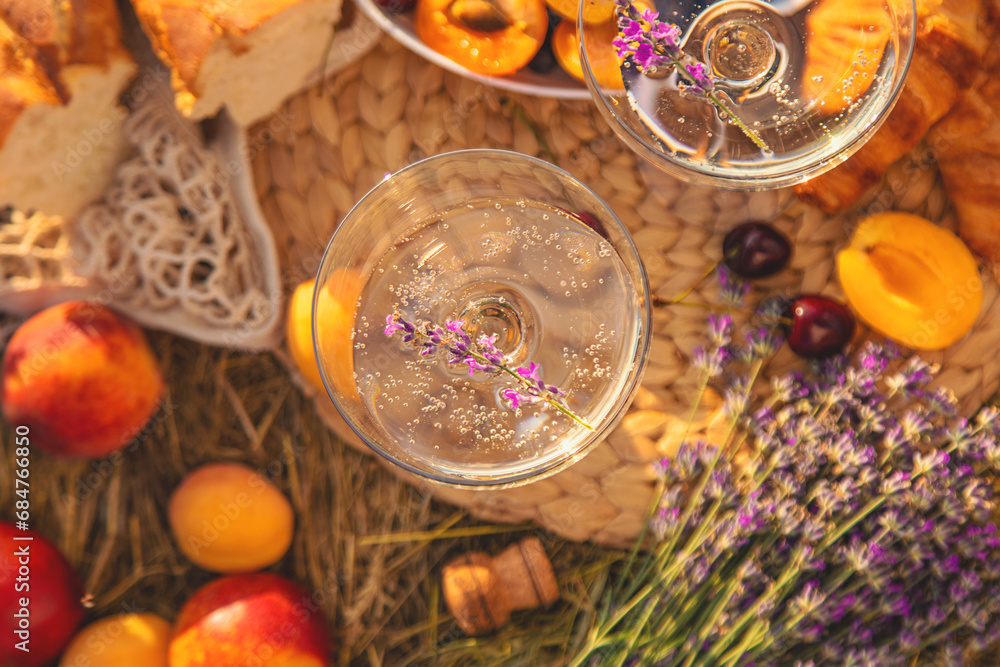 Picnic with wine in a lavender field. Selective focus. Picnic with wine in a lavender field. Selective focus.