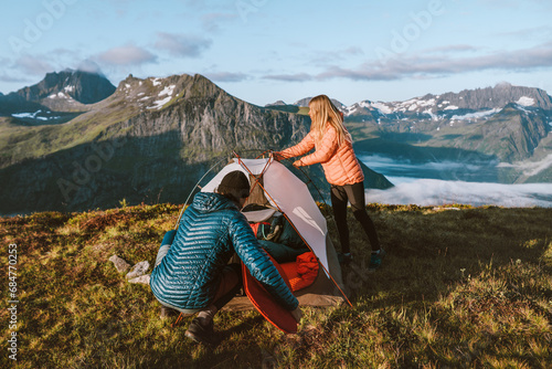 Couple friends set tent camping gear in mountains active travel lifestyle vacations outdoor, man and woman hiking together in Norway, family adventures eco tourism healthy lifestyle hobby