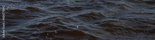 Dramatic dark ocean waves banner. Abstract wine-dark sea background. Minimal blue water banner. 