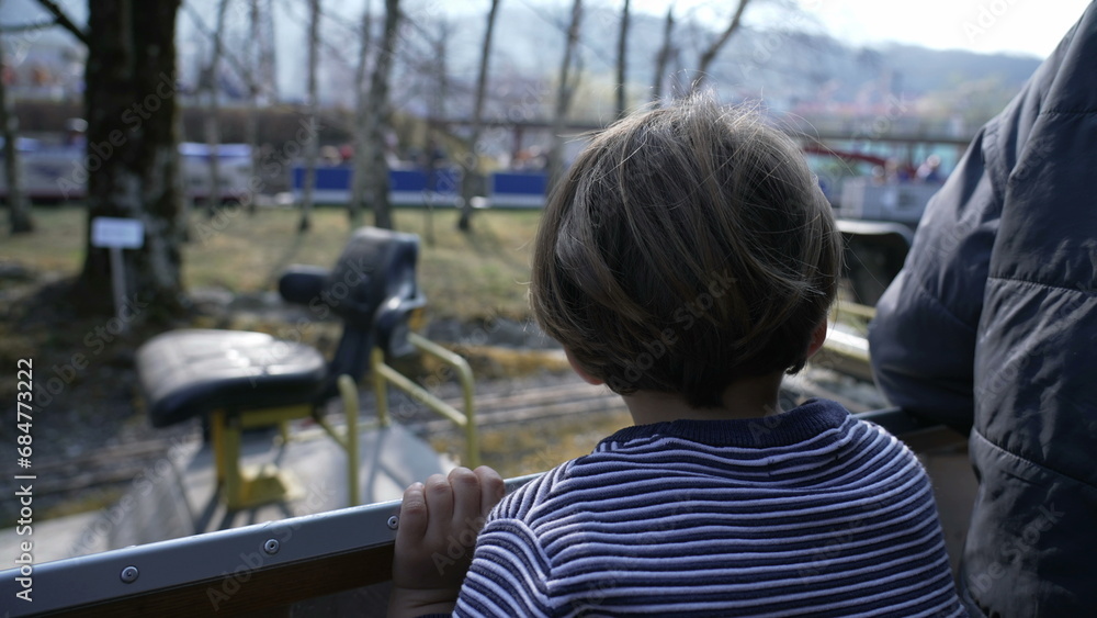 Young Passenger Small Boy Watches Scenery Pass by on Miniature Train Ride at Swiss Vapeur Park Young Passenger Small Boy Watches Scenery Pass by on Miniature Train Ride at Swiss Vapeur Park