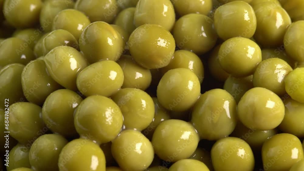 Canned green pea kernels close up rotate for cooking background side view. Marinated pickled sweet green peas Canned green pea kernels close up rotate for cooking background side view. Marinated pickled sweet green peas