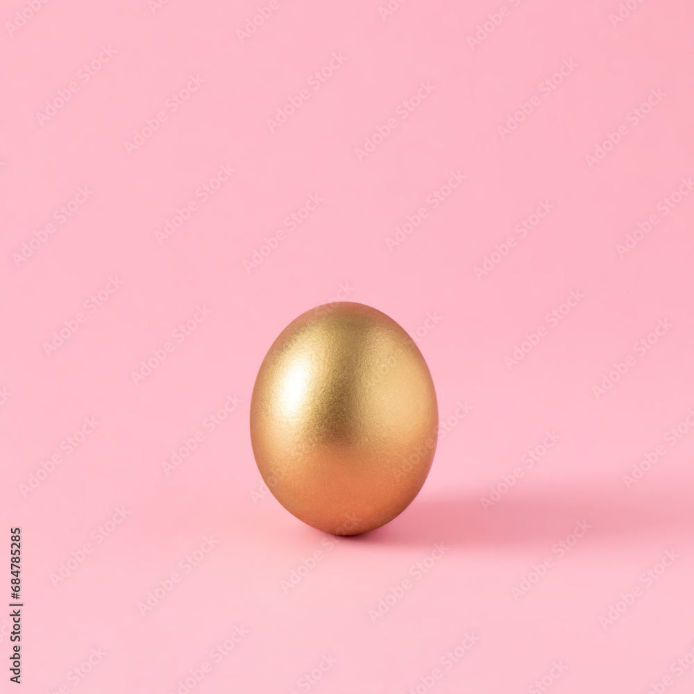 Golden Easter egg on pastel pink background. Minimal aesthetic Christian holiday composition. Trendy layout. Golden Easter egg on pastel pink background. Minimal aesthetic Christian holiday composition. Trendy layout.