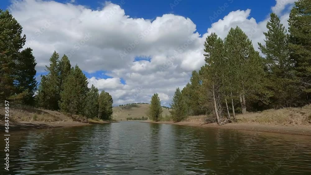 Gliding over the waters surface at lake in Montana through small channel.