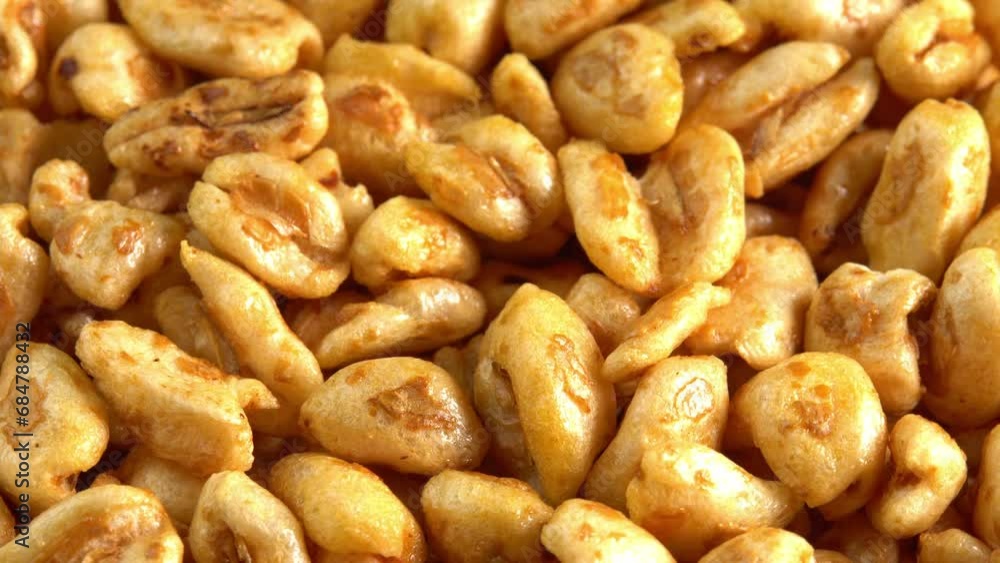 Roasted sweet puffed wheat rotate in macro like background side view. Dry breakfast to recharge your vital energy for the working day Roasted sweet puffed wheat rotate in macro like background side view. Dry breakfast to recharge your vital energy for the working day