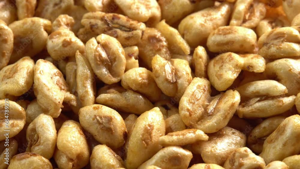 Roasted sweet puffed wheat rotate in macro like background side light. Dry breakfast to recharge your vital energy for the working day