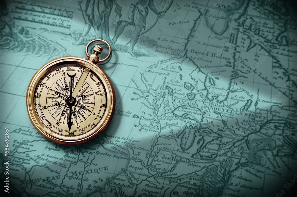 Magnetic retro old compass and world map.