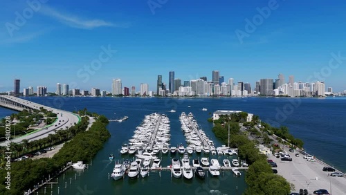 Drone view on Virginia Key coastline and rich Miami disrtict opposite. Stunning area for recreation with luxury boats and riding cars on bridge roadway across ocean. photo