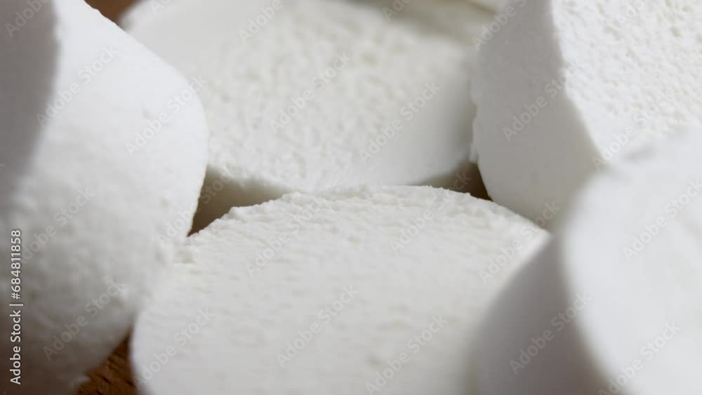 Sliced Chevre goat soft cheese. Traditional dairy product. Rotation. Macro shot Sliced Chevre goat soft cheese. Traditional dairy product. Rotation. Macro shot