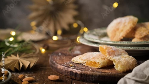 A crescent-shaped pastry whose filling is made of eggs and almonds wrapped in crispy dough, cut in an artisanal way and sprinkled with sugar. photo