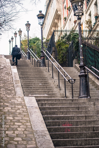 man walking upstairs in Paris France