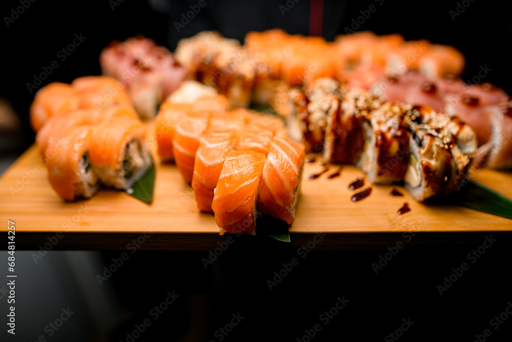 Rolling into Taste. Tuna, Sesame, Teriyaki Sushi on Leafy Canvas Rolling into Taste. Tuna, Sesame, Teriyaki Sushi on Leafy Canvas