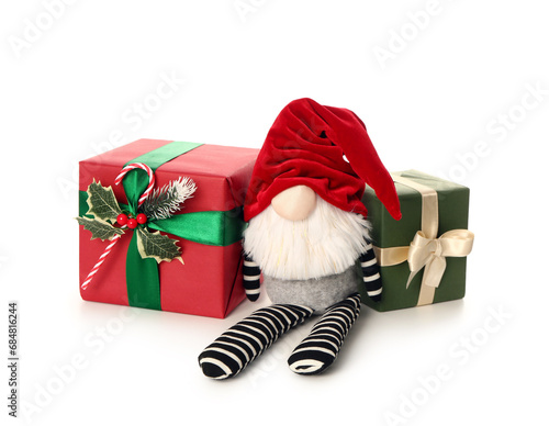 Christmas gnome with gift boxes isolated on white background