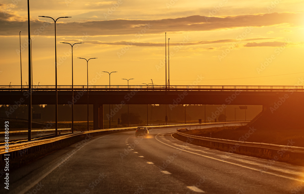 Highway after the rain at sunset in summer.