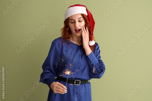 Young woman in Santa hat wi...