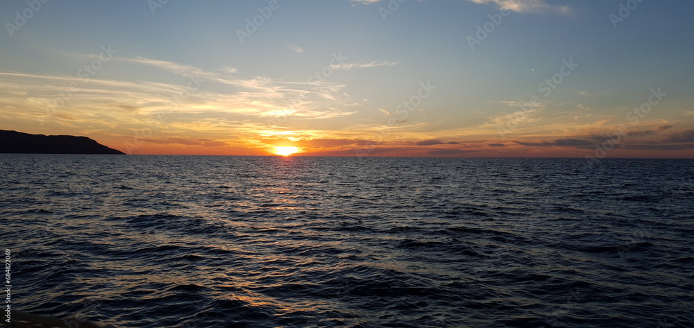 Calm sea at sunset with beautiful sky and peaceful horizon