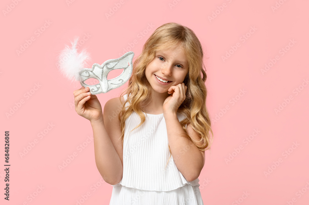Cute little girl with carnival mask on pink background Cute little girl with carnival mask on pink background