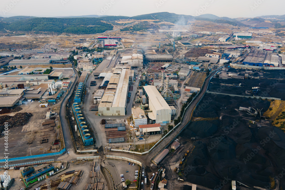 Heavy industry park with power plant and coal bulk storage terminal with coal heaps. Aerial panorama shot