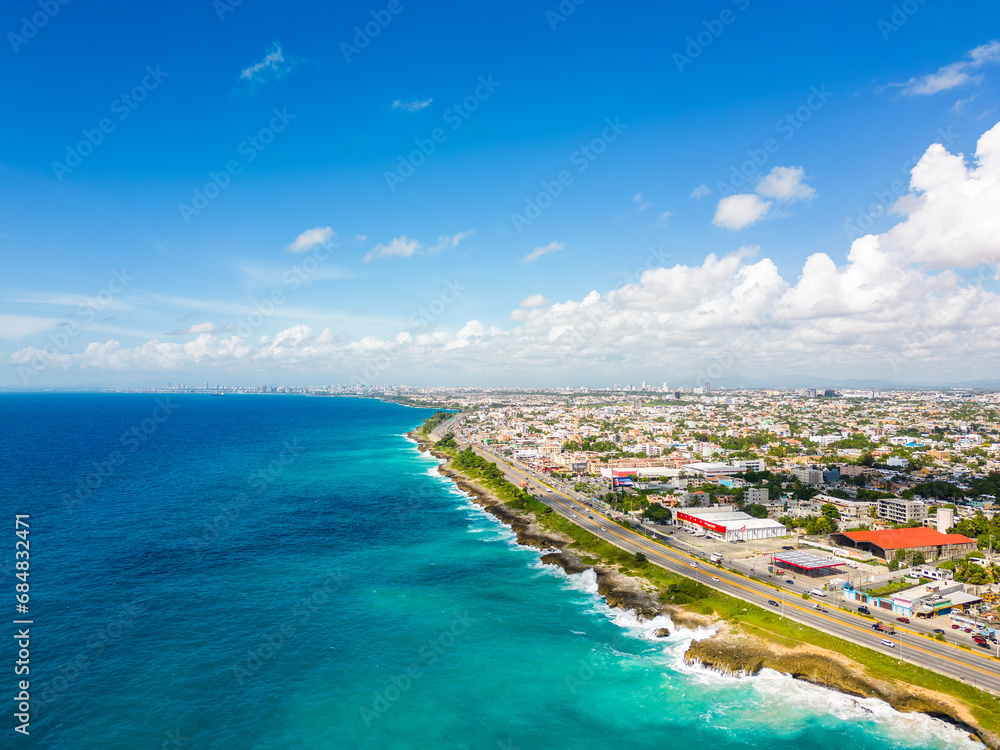 Aerial view of Santo Domingo este. The Autopista Las Americas along the rocky shore of turquoise caribbean sea. Expressway from the Punta Cana to the capital of Dominican Republic