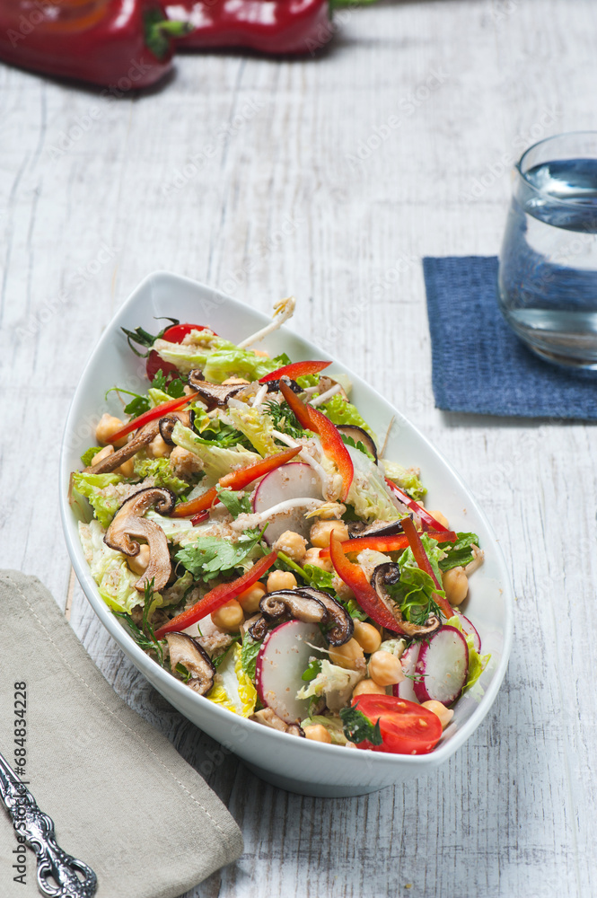 High angle view photo of a mixed green salad in a white modern bowl High angle view photo of a mixed green salad in a white modern bowl