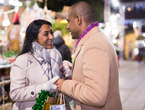 Portrait of happy couple in love at christmas street fair