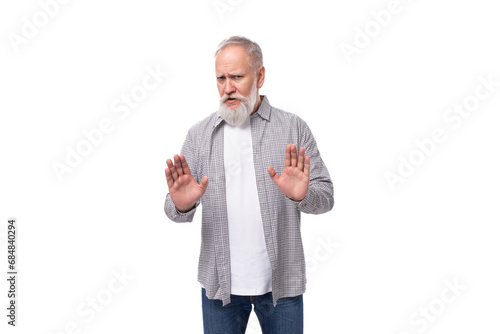 handsome retired man with a beard and a big mustache is dressed in a shirt and jeans