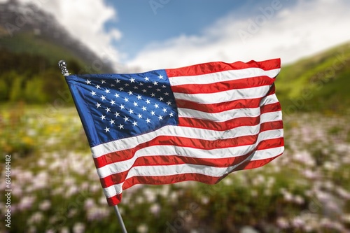 American flag wave over a flowers field.