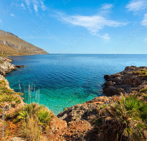 Paradise sea bay with azure water and beach view from coastline trail of Zingaro Nature Reserve Park, between San Vito lo Capo and Scopello, Trapani province, Sicily, Italy. Two shots stitch image.