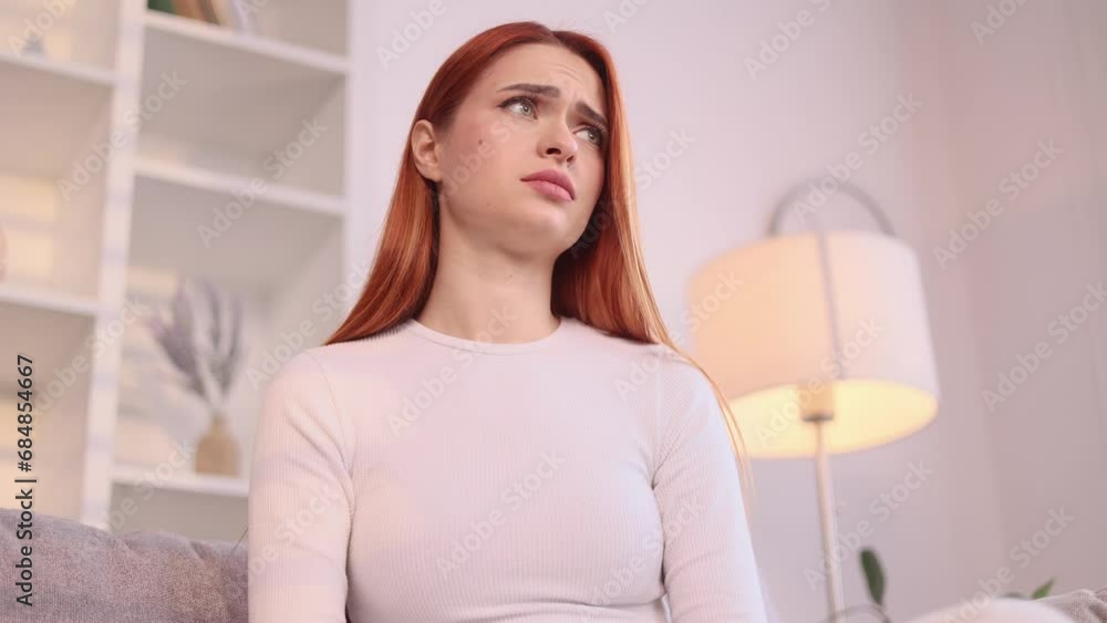 Attractive young red haired woman at home get notification and feeling upset reading bad negative news message on smartphone and looking at camera indoors Disappointment Fail Unemployment Attractive young red haired woman at home get notification and feeling upset reading bad negative news message on smartphone and looking at camera indoors Disappointment Fail Unemployment