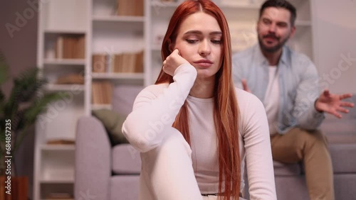 Portrait of young woman feeling stress and pressure from her husband or boyfriend while he screaming at her Sad male suffering from depression anxiety loneliness or mental health problem Home abuse photo