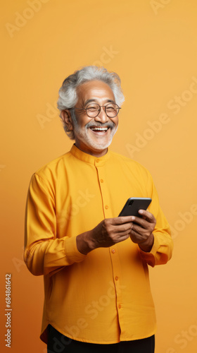 Senior asian man, portrait and phone for social media app, internet and website on color background mockup. Face, smile and happy pensioner with mobile technology for influencer blog post in house wi © Allistair/Peopleimages - AI